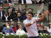 Federer of Switzerland hits a return to Carreno-Busta of Spain during their men's singles match at the French Open tennis tournament in Paris