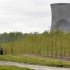 FILE - In this May 18, 2011 file photo, a worker  is seen in the area surrounding a tree farm in North Perry, Ohio, near the two cooling towers of the Perry Nuclear Power Plant looming in the background. The risk of an earthquake causing a severe accident at a nuclear power plant is up to 24 times greater than previously believed, according to an AP analysis of preliminary government data, and the nation’s nuclear regulator believes that a quarter of reactors may need modifications to make them safer. The Nuclear Regulatory Commission says more than two dozen plants in the eastern and central U.S. may need upgrades because they're more likely to get hit with an earthquake larger than the one their design was based on. It's a belated conclusion; for more than a decade, regulators ignored the evidence of increased quake risks.  (AP Photo/Amy Sancetta, File)