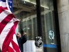 A worker lowers the U.S. flag outside of NHL headquarters in New York