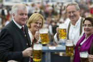 Bavarian Prime Minister Horst Seehofer, his wife Karin, Munich's Mayor Christian Ude and his wife Edith Welser-Ude toast with their beer mugs during the opening ceremony of the famous Bavarian "Oktoberfest" beer festival in Munich, southern Germany, Saturday, Sept. 22, 2012. The world's largest beer festival, to be held from Sept. 22 to Oct. 7, 2012 will see some million visitors. (AP photo/dapd, Lennart Preiss)
