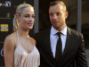 In this Nov. 4,  2012 photo, South African Olympic athlete Oscar Pistorius and Reeva Steenkamp, believed to be his girlfriend, at an awards ceremony, in Johannesburg, South Africa.  Olympic athlete Oscar Pistorius was taken into custody and was expected to appear in court Thursday, Feb. 14, 2013,  after a 30-year-old woman who was believed to be his girlfriend was shot dead at his home in South Africa's capital, Pretoria. (AP Photo/Lucky Nxumalo-Citypress) SOUTH AFRICA OUT
