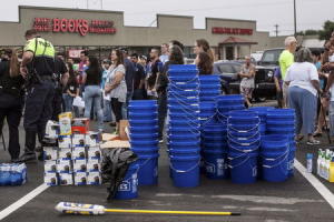 Volunteers gather in a shopping center parking lot &hellip;