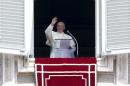 Pope Francis waves as he delivers his Sunday Angelus prayer from the window of the Apostolic Palace in Saint Peter's Square at the Vatican