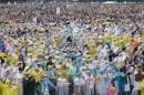 Nuns and Catholic faithful dance as they wait for a Mass by Pope Francis at Rizal Park in Manila