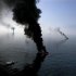 Smoke billows from a controlled burn of spilled oil off the Louisiana coast in the Gulf of Mexico coast line