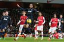 Manchester United's Chris Smalling, centre, watches as the ball goes past and he misses an chance on goal during their English Premier League soccer match between Arsenal and Manchester United at the Emirates stadium in London, Wednesday, Feb. 12, 2014. (AP Photo/Alastair Grant)