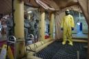 A soldier goes through the decontamination process with U.S. Army soldiers from the 101st Airborne Division (Air Assault), who are earmarked for the fight against Ebola, take part in training before their deployment to West Africa, at Fort Campbell