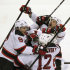 New Jersey Devils' Zach Parise (9), Alexei Poonikarovsky (12), Marek Zidlicky (2) and David Clarkson, top right, mob Adam Henrique, obsucred, after he scored during the second overtime against the Florida Panthers in Game 7 in a first-round NHL Stanley Cup playoff hockey series in Sunrise, Fla., Wednesday, April 26, 2012. The Devils won 3-2. (AP Photo/J Pat Carter)