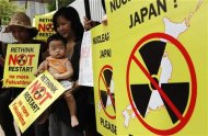 A mother and her child join a protest against the Japanese government's decision to restart two nuclear reactors, in front of the Japanese embassy in Bangkok June 15, 2012. REUTERS/Sukree Sukplang