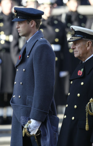 Britain's Prince William, Duke of Cambridge, left, and The Duke of Edinburgh, right, stand during the service of remembrance at the Cenotaph in Whitehall, London, Sunday, Nov. 13, 2011. Queen Elizabeth II and other senior members of the royal family were leading the annual Remembrance Day ceremony in central London Sunday to honor the nation's war dead. (AP Photo/Kirsty Wigglesworth)