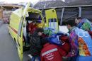A track worker is loaded into an ambulance after he was injured when a forerunner bobsled hit him just before the start of the men's two-man bobsled training at the 2014 Winter Olympics, Thursday, Feb. 13, 2014, in Krasnaya Polyana, Russia. (AP Photo/Charlie Riedel)