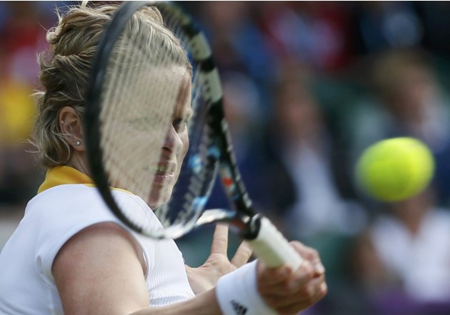 Belgium's Clijsters returns to Russia's Sharapova in their women's singles quarterfinals tennis match at the All England Lawn Tennis Club during the London 2012 Olympic Games