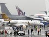Visitors walk among planes displayed at the 50th Paris Air Show at Le Bourget airport, north of Paris, Wednesday June 19, 2013. Visible at foreground is a Bombardier Global 6000 jet.(AP Photo/Remy de la Mauviniere)