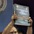 Deputy Comptroller and Auditor General of India Rekha Gupta holds up the audit report on the 2010 Commonwealth Games, during a press conference in New Delhi, India, Friday, Aug. 5, 2011. India's top auditing body on Friday slammed the preparations and conduct of the games last year as deeply flawed, riddled with favoritism and vastly more expensive than planned. (AP Photo/Manish Swarup)