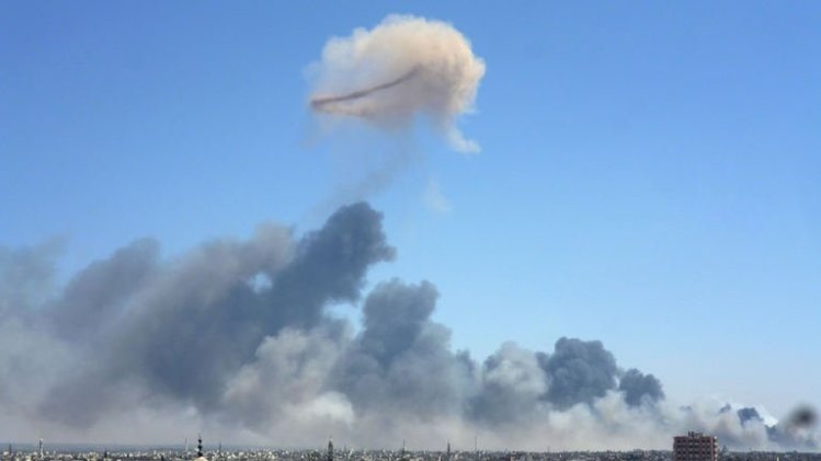 Smoke billows from the site of an ammunitions depot blast in the Wadi al-Zahab district of Homs, on August 1, 2013
