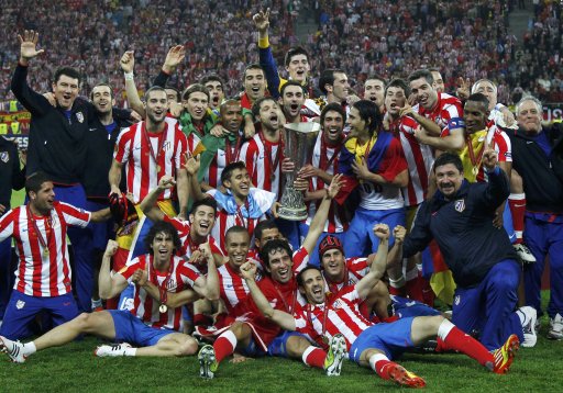 Atletico Madrid's players celebrate with the trophy after defeating Athletic Bilbao to win the Europa League final soccer match at the National Arena in Bucharest
