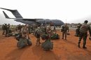 French soldiers carry their equipment after arriving on a US Air Force C-17 transport plane in Bamako
