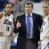Connecticut head coach Geno Auriemma, center, speaks with Bria Hartley, left, and Caroline Doty during the first half of an NCAA tournament second-round college basketball game against Kansas State in Bridgeport, Conn., Monday, March 19, 2012. Connecticut won 72-26. (AP Photo/Jessica Hill)