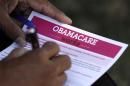 A man fills out an information card during an Affordable Care Act outreach event hosted by Planned Parenthood for the Latino community in Los Angeles, California
