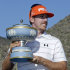 Hunter Mahan holds the Walter Hagan Cup after winning the Match Play Championship golf tournament with a 2 and 1 final round over Rory McIlroy, Sunday, Feb. 26, 2012, in Marana, Ariz. (AP Photo/Matt York)