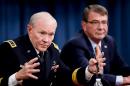 Joint Chiefs Chairman Gen. Martin Dempsey, left, accompanied by Defense Secretary Ash Carter, right, speaks during a news conference at the Pentagon, Thursday, April 16, 2015. (AP Photo/Andrew Harnik)