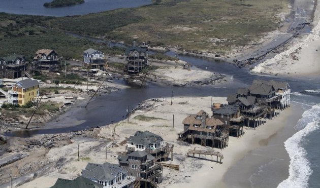 A flooded road is seen in Hatteras Island, N.C., Sunday, Aug. 28, 2011, after  Hurricane Irene swept through the area Saturday cutting the roadway in five locations. Irene caused more than 4.5 million
