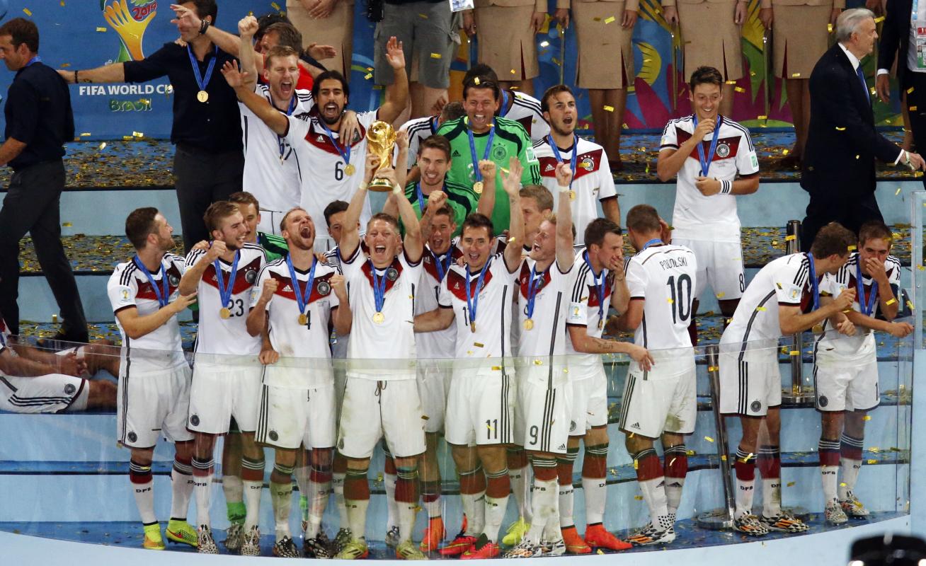 Germany team celebrate after winning the World Cup final soccer match between Germany and Argentina at the Maracana Stadium in Rio de Janeiro, Brazil, Sunday, July 13, 2014. Mario Goetze volleyed in the winning goal in extra time to give Germany its fourth World Cup title with a 1-0 victory over Argentina on Sunday. (AP Photo/Fabrizio Bensch, Pool)
