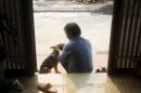 Teacher Do Viet Khoa plays with his dog at his hometown in Thuong Tin