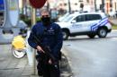 A Belgian police officer stands guard during an anti-terror raid in the Schaerbeek - Schaarbeek district of Brussels, on March 25, 2016