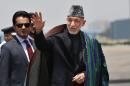 FILE - This May 26, 2014 file photo shows Afghan President Hamid Karzai in New Delhi, India. Civilian assistance to Afghanistan was always slated to shrink with America's military footprint, but U.S. aid officials were caught off-guard when Congress, upset by testy relations with Afghan President Hamid Karzai, slashed civilian aid by 50 percent this year. War-weary lawmakers, content with the level of Afghan aid already in the pipeline, backed the cut, but officials with the U.S. Agency for International Development warn that reducing aid too quickly is risky. (AP Photo/Saurabh Das, File)