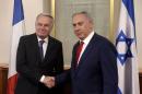 Israeli Prime Minister Benjamin Netanyahu shakes hands with French Foreign Minister Jean-Marc Ayrault