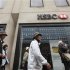 Tourists pass an HSBC bank in central London