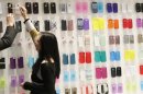 A visitor looks at mobile phone covers at the Mobile World Congress in Barcelona