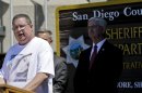 Brett Anderson, wearing a shirt featuring a photo of his daughter, Hannah, makes a statement regarding her kidnapping and rescue at a news conference Monday, Aug. 12, 2013, in San Diego. Anderson is flanked by San Diego County Sheriff William Gore. James Lee DiMaggio, 40, suspected of killing Hannah's mother and brother before fleeing with her in the Idaho wilderness, was killed in a shootout with law enforcement on Saturday. (AP Photo/Lenny Ignelzi)