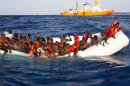 Migrants sit in a rubber dinghy during a rescue operation by SOS Mediterranee ship Aquarius off the coast of the Italian island of Lampedusa