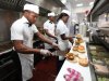 In this photo taken, Wednesday, Jan. 23, 2013 workers prepare hamburgers   at Johnny Rockets restaurant in Lagos, Nigeria. As Nigeria’s middle class grows along with the appetite for foreign brands in Africa’s most populous nation, more foreign restaurants and lifestyle companies are entering the country. And the draw on Nigerians’ new discretionary spending has also put new expectations on providing quality service in a nation where many have grown accustomed to expecting very little. ( AP Photo/Sunday Alamba)