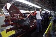 Workers assemble a pre-production 2013 Dodge Dart during a tour of the Chrysler Belvidere Assembly plant in Belvidere, Illinois February 2, 2012. REUTERS/Frank Polich