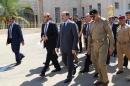 Caretaker Iraqi Prime Minister Nuri al-Maliki (3rd L) walks in the grounds of the Defence Ministry in the capital Baghdad during the funeral of Major General Majid Abdul Salam on August 13, 2014