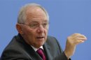 German Finance Minister Schaeuble gestures as he addresses a news conference to presents 2014 federal budget bill in Berlin
