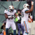 Miami Dolphins' Olivier Vernon (50) celebrates with teammate Jonathan Freeny (59) after returning a blocked punt for a touchdown during the first half of an NFL football game against the New York Jets, Sunday, Oct. 28, 2012, in East Rutherford, N.J. (AP Photo/Bill Kostroun)
