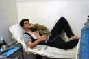 A young man breathes with an oxygen mask on March 17, 2015 at a clinic in the village of Sarmin, southeast of Idlib, the capital of Syria's northwestern province of Idlib, following an alleged regime gas attack in the area