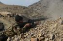 An Afghan National Army soldier fires during an ongoing anti-Taliban operation in Dangam district near the Pakistan-Afghanistan border in the eastern Kunar province on January 3, 2015