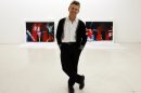 In this Tuesday, Feb. 21, 2012 photo, dancer Mikhail Baryshnikov, poses with two of the photographs he will be exhibiting at the Gary Nader Art Centre in Miami. The show, which opens Friday, Feb. 24, is titled â€œDance This Wayâ€ and features large-scale photographs of ethnic, hip-hop, ballet, modern and popular dances performed on stage by professionals and in nightclubs by amateurs. (AP Photo/Wilfredo Lee)