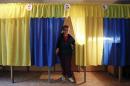 Election commission worker Pozhidaeva demonstrates the readiness of a polling station for Sunday's referendum in the eastern Ukrainian city of Lugansk