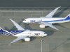 All Nippon Airways Boeing 787 planes sit on a tarmac at Haneda Airport in Tokyo Friday, April 26, 2013. Japan's transport minister said Friday the government is poised to allow Japanese airlines to resume flying grounded Boeing 787s once they complete installation of systems to reduce fire risk in problematic lithium ion batteries. (AP Photo/Kyodo News) JAPAN OUT, MANDATORY CREDIT, NO SALES IN CHINA, HONG KONG, JAPAN, SOUTH KOREA AND FRANCE