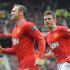 Manchester United's Wayne Rooney (L) celebrates with teammate Michael Carrick after scoring against QPR