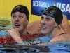 Allison Schmitt (L) and Missy Franklin check their times after their women's 200m freestyle semifinal during the U.S. Olympic swimming trials in Omaha