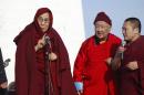 The Dalai Lama, left, speaks at the Janraiseg Temple of Gandantegchinlen monastery in Ulaanbaatar, Mongolia, Saturday, Nov. 19, 2016. The Dalai Lama has preached to thousands of supporters Saturday in Mongolia on a visit set to test the country's ties with its powerful neighbor, China. (AP Photo/ Ganbat Namjilsangarav)