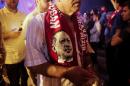 A supporter wears a scarf depicting Turkish President Tayyip Erdogan during a pro-government demonstration at Taksim square in Istanbul