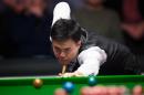 Hong Kong snooker player Marco Fu plays a shot during his first round match against England's Stuart Bingham at the Masters snooker tournament at Alexandra Palace in north London on January 11, 2015